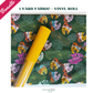 A product bundle promotional image with a white border. A pink ribbon graphic in the top-left corner reads "Bundle," and green text at the top reads "1 VINYL ROLL + 2 YARD FABRIC." The main photo shows a roll of textured, bright yellow vinyl fabric placed diagonally across a dark green fabric. The fabric is patterned with vibrant, multi-colored monstera and palm leaves in shades of pink, yellow, orange, and blue. The "sewhungryhippie" logo is centered at the bottom.