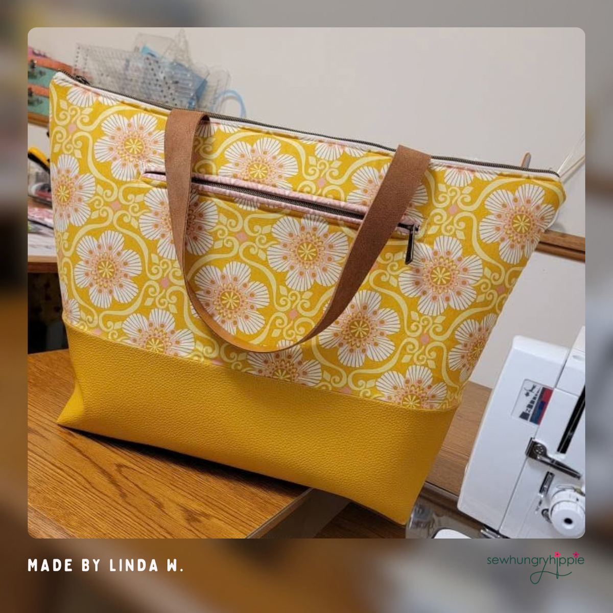 Tote in yellow and white floral print with mustard Moonglow vinyl base and brown handles, made by Linda M.