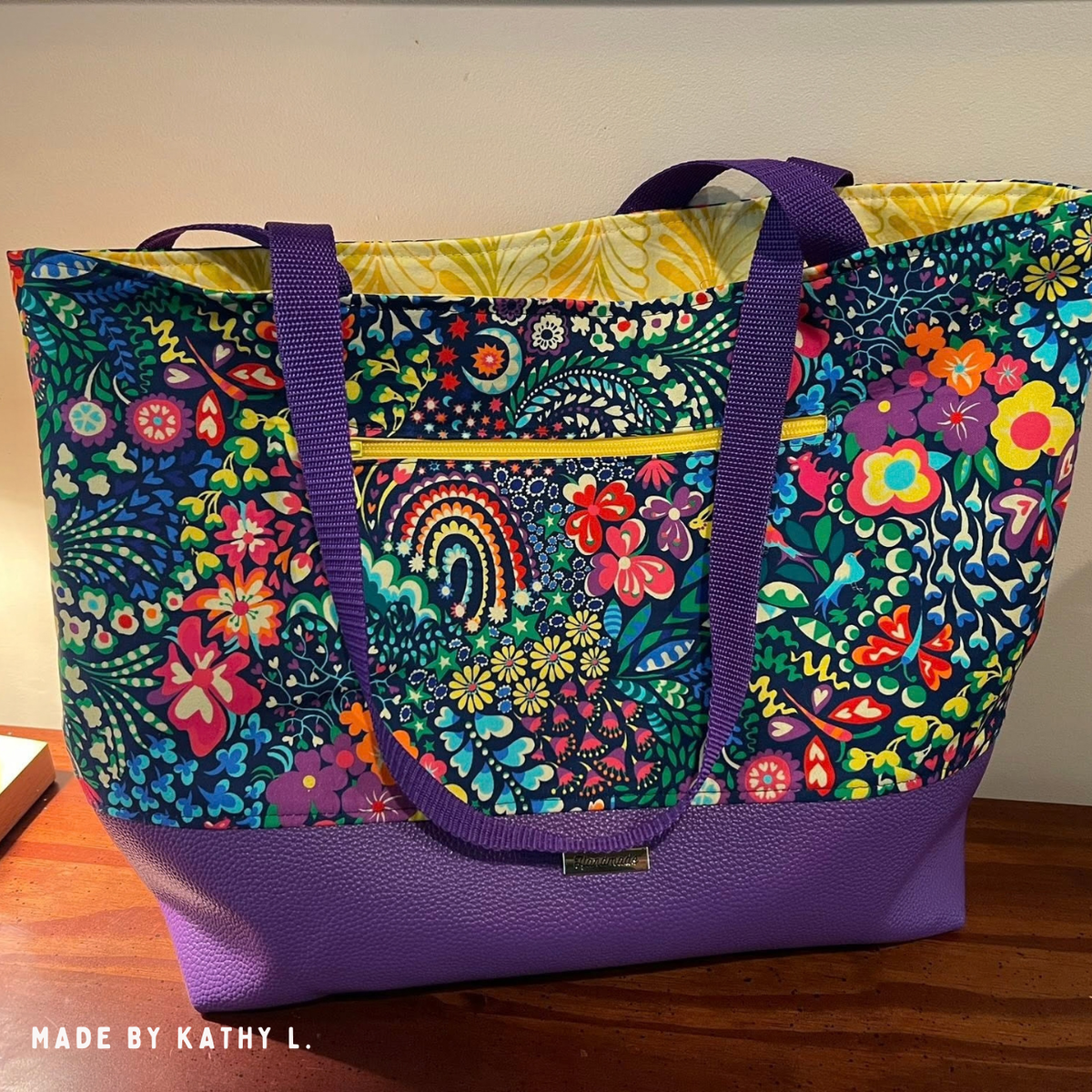 Tote in bright folk floral print with a Moonglow purple vinyl base