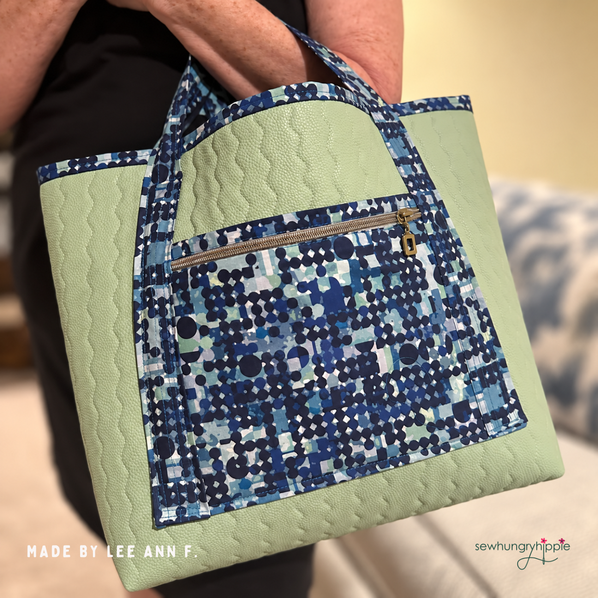 Bag in sage green quilted vinyl with a blue mosaic print front pocket