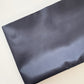 Dark blue satin fabric on a white background