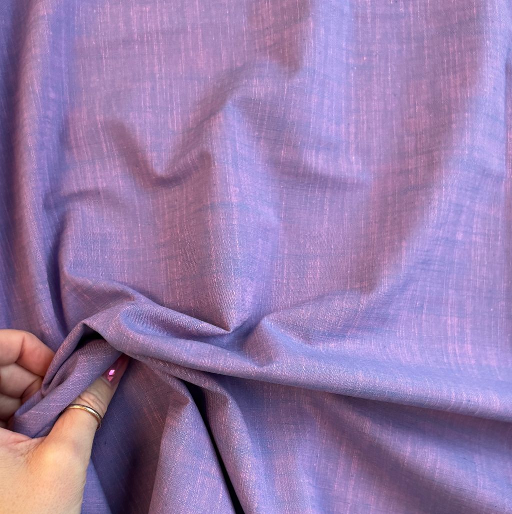 Hand holding picnic wovens slub in Grape Jelly fabric by Suzy Quilts for Art Gallery Fabrics, yarn dyed 100 percent cotton woven material, SKU PWOV-2019.