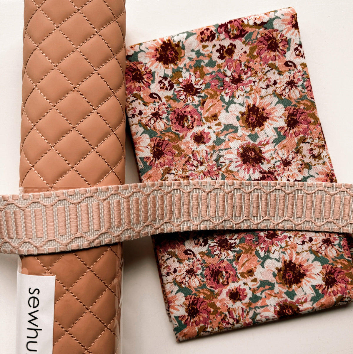Peach Floral Bundle from SewHungryhippie, which includes bag-making materials. Pre-quilted vinyl roll, floral fabric, peach webbing