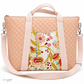 A quilted peach tote bag with a floral front panel and a light pink striped shoulder strap, shown on a white background.