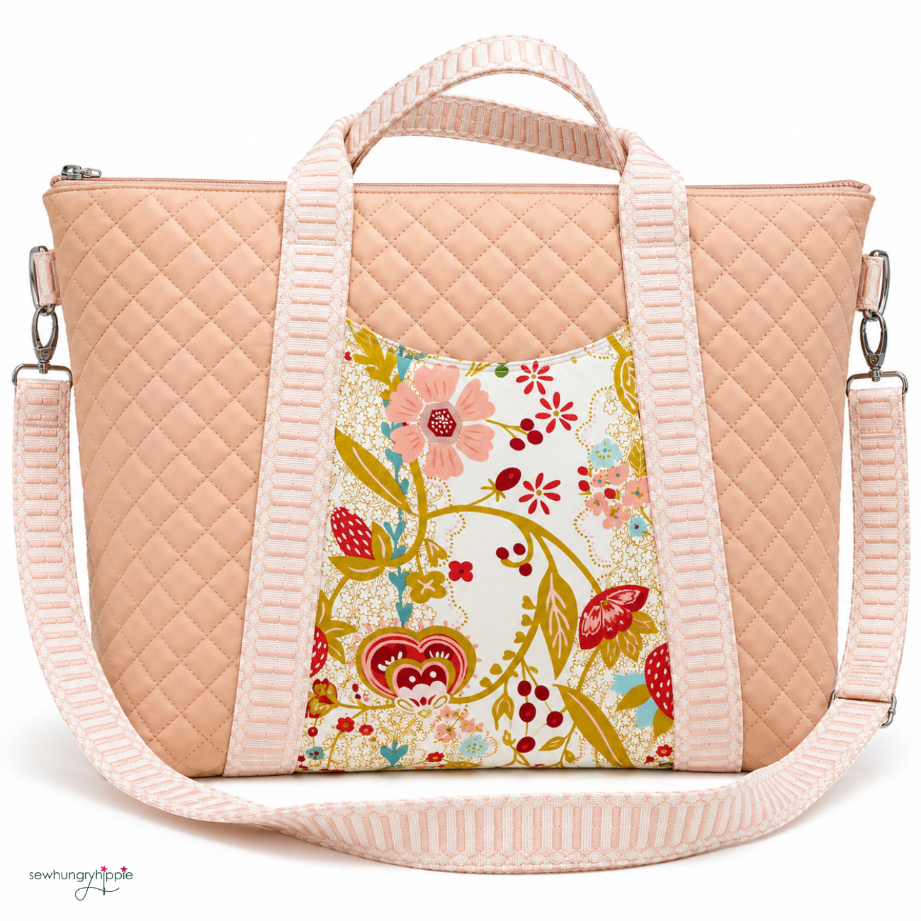 A quilted peach tote bag with a floral front panel and a light pink striped shoulder strap, shown on a white background.