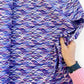 Hand holding Purple Geometric Cotton Fabric from Perfect Day Libs Elliot