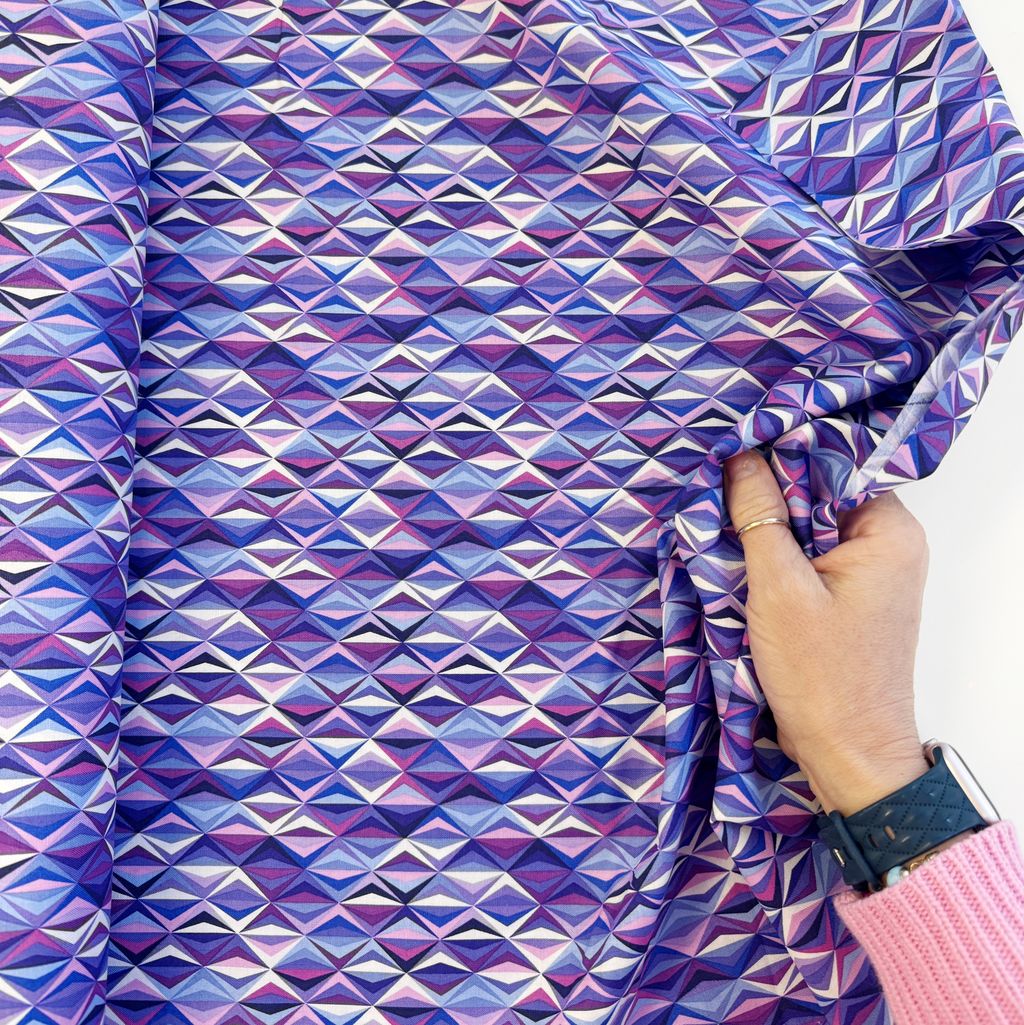 Hand holding Purple Geometric Cotton Fabric from Perfect Day Libs Elliot