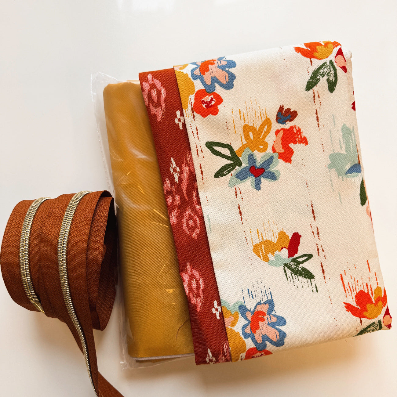 Coordinated boho fabric bundle with cotton quilting fabric, bonded nylon material, and zipper tape for purses and bags