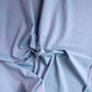 Drape close up view of textured light blue Slub in Blueberry fabric from the Picnic Wovens collection by Suzy Quilts for Art Gallery Fabrics, SKU PWOV-2018.