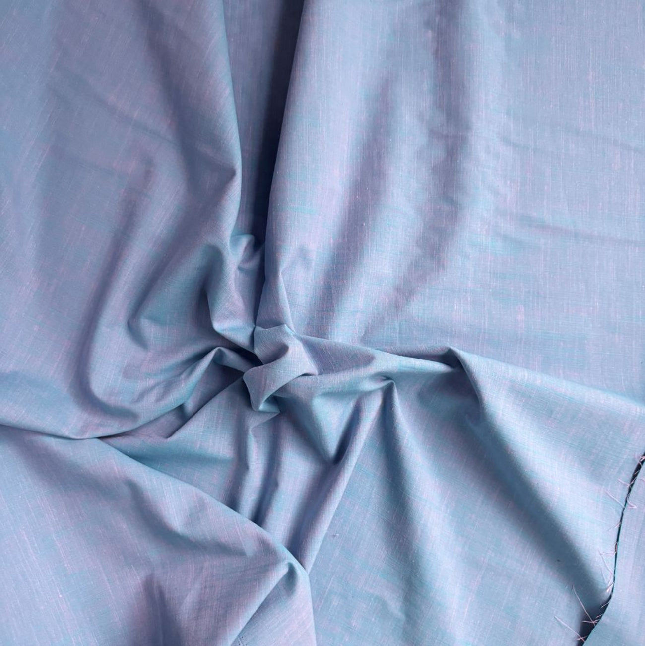 Drape close up view of textured light blue Slub in Blueberry fabric from the Picnic Wovens collection by Suzy Quilts for Art Gallery Fabrics, SKU PWOV-2018.