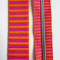 A matching bag making set featuring a thick jacquard woven webbing strap on the left and a continuous zipper tape with metallic silver coil teeth on the right, both showcasing an identical bright pink and orange horizontal stripe pattern.