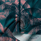 Dark blue tropical palm print cotton fabric by Ruby Star Society, shown in a soft draped close-up featuring layered teal and blush pink palm leaves with a flowing texture perfect for quilting, apparel, bags, and tropical-inspired sewing projects.