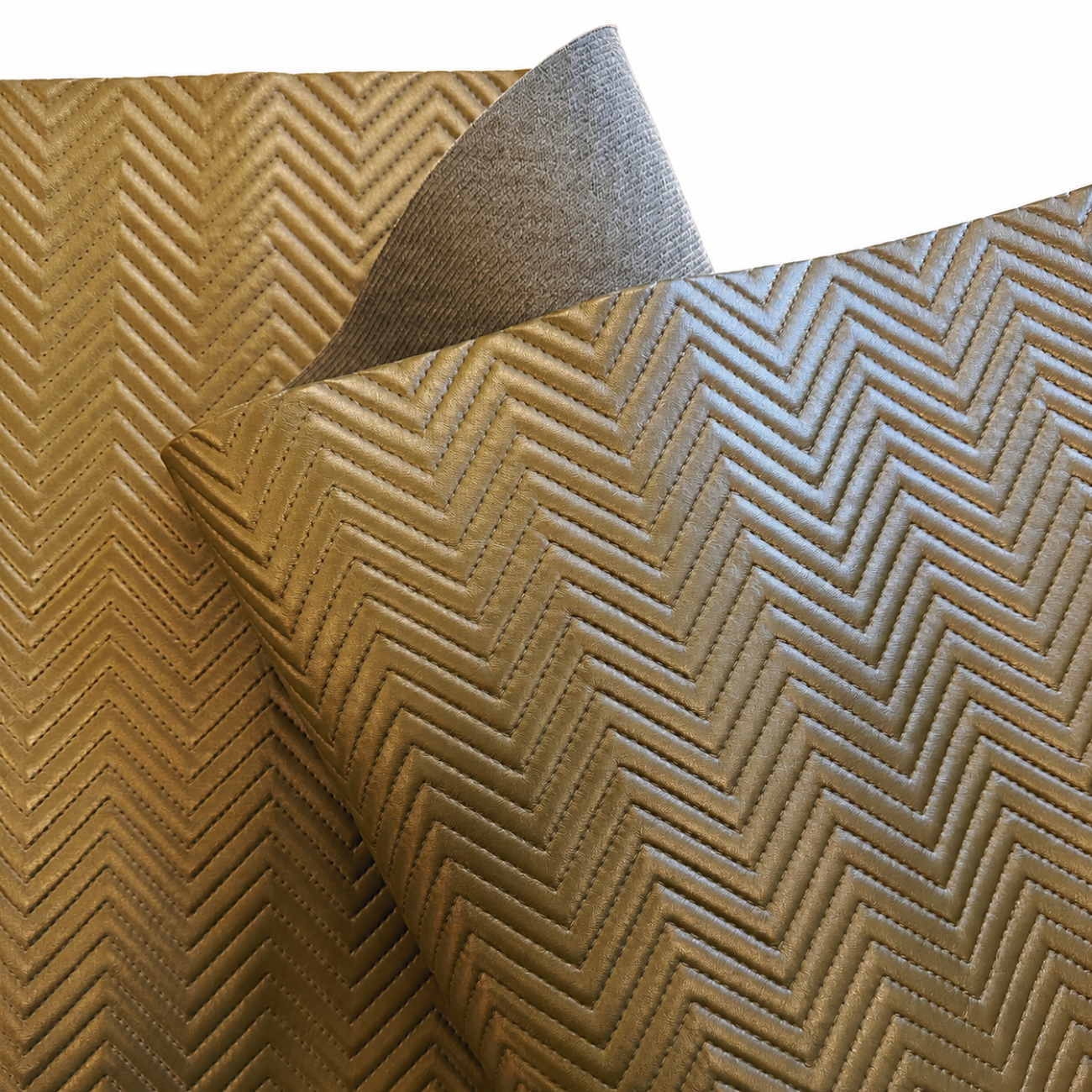 Quilted chevron vinyl fabric in warm olive-tan color with raised stitched texture and soft backing shown in a professional white background studio shot.