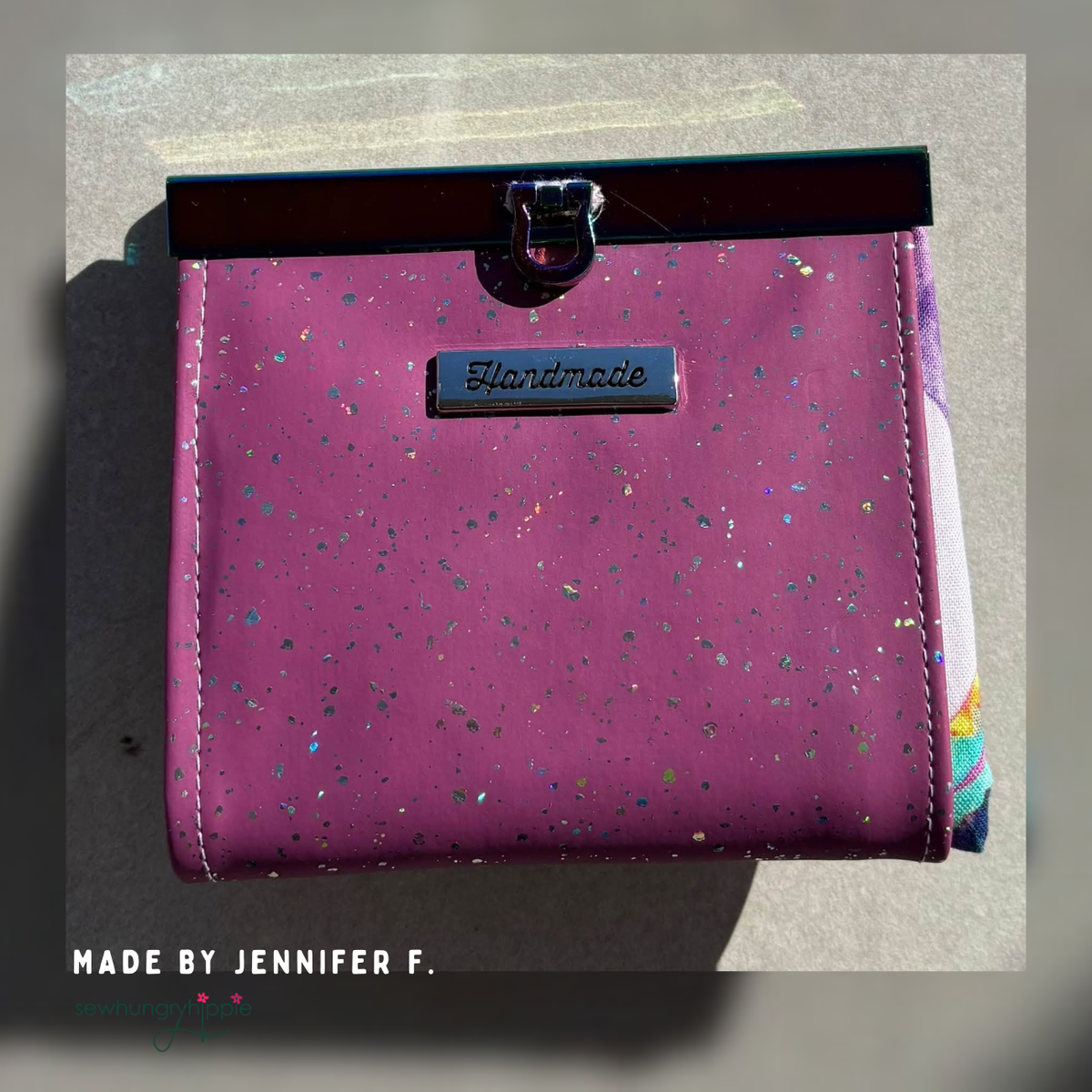 Bag in purple mauve sparkle vinyl with a black tab closure