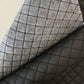 Pre-quilted black vinyl fabric with padded diamond pattern for tote bags and purses