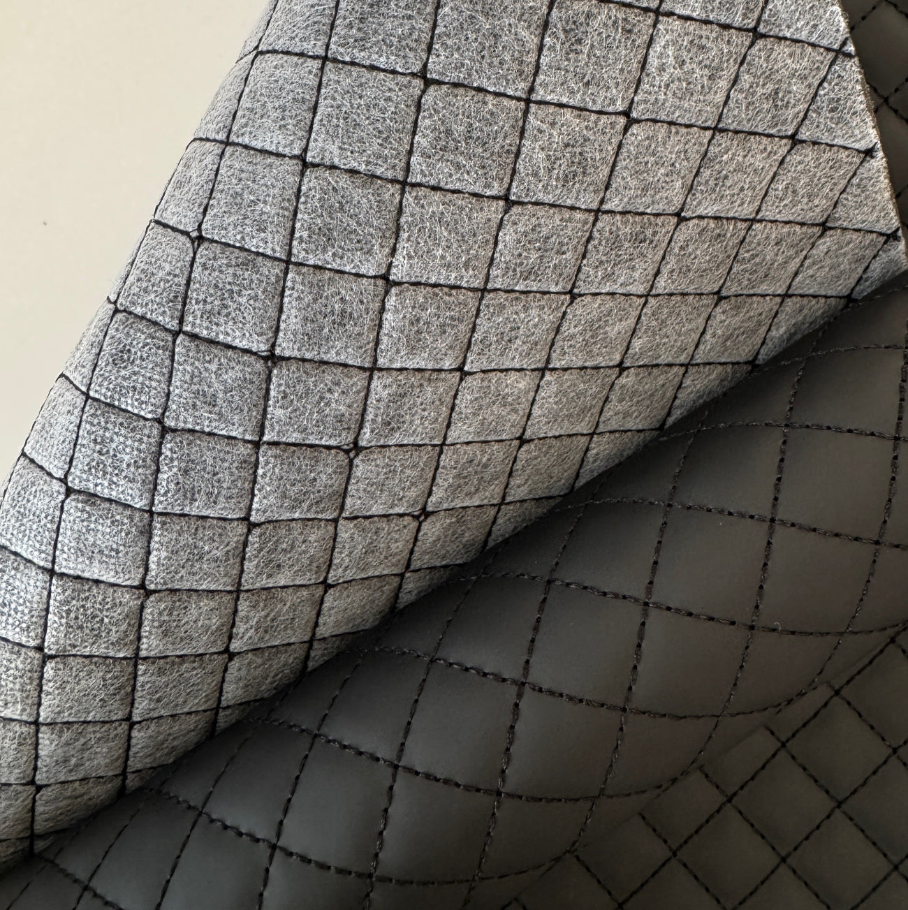 Pre-quilted black vinyl fabric with padded diamond pattern for tote bags and purses
