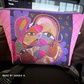 Bag with a colorful folk art face panel and Pink Paradise quilted vinyl sides