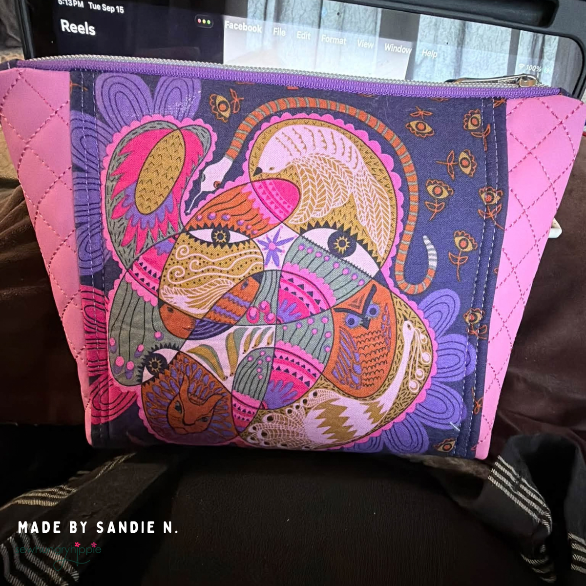 Bag with a colorful folk art face panel and Pink Paradise quilted vinyl sides