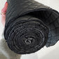 Quilted black vinyl fabric roll with padded texture for bag making projects