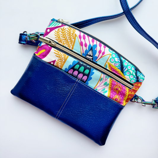 Blue crossbody bag with colorful floral pattern