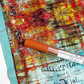 Sewing fabrics and vinyl 'sewhungryhippie' label on a textured surface with colorful abstract design