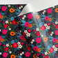 Colorful floral patterned paper with a dark background