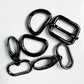 Five black metal carabiner clips and loops arranged on a plain white background.