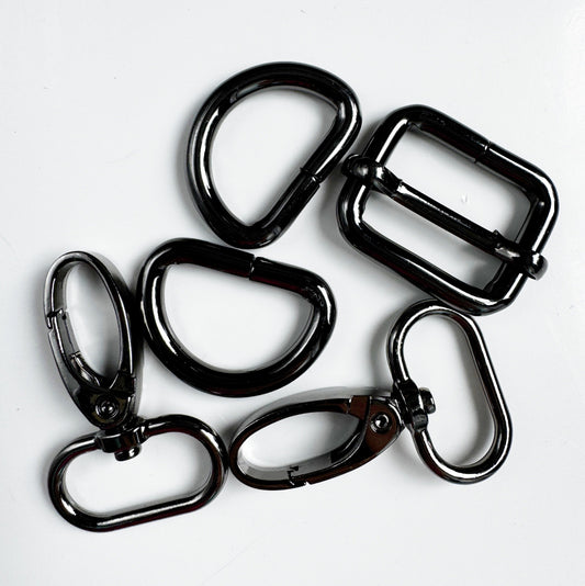 Five black metal carabiner clips and loops arranged on a plain white background.