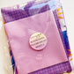 An unopened Sew Hungry Hippie sewing kit featuring Alison Glass fabrics in shades of purple and pink polka dots, labeled "Alison Glass Pillowcase Kit Makes 2."
