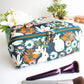 Floral and bunny-themed makeup bag with a brush on a white surface made from the Spring Roll Pouch sewing pattern from Love You Sew Patterns