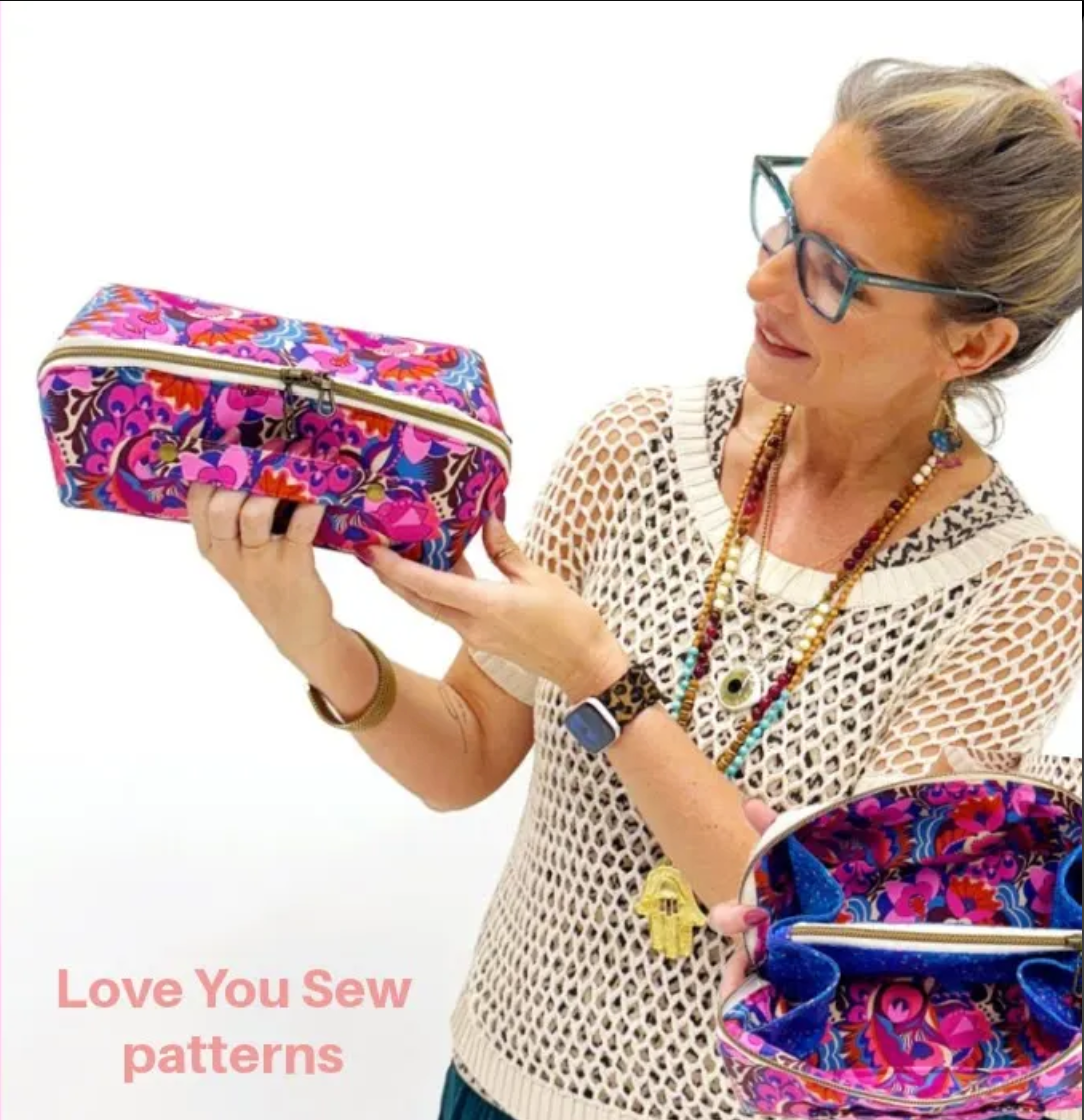 Natalie holding handmade pink floral bag against a white background