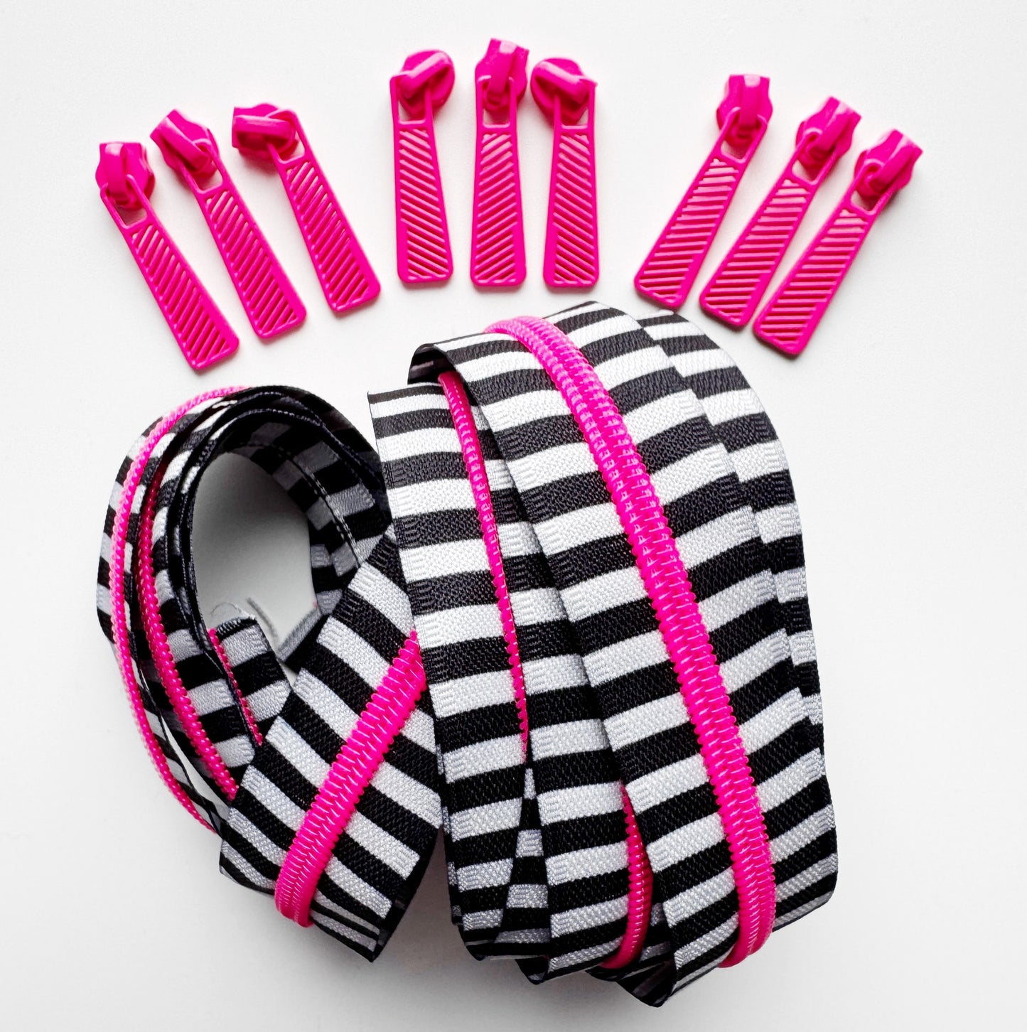 Black & white striped zipper tape with pink zipper pulls