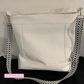 Stylish DIY Aspen Crossbody Bag sewn with white moonglow vinyl and black and white braided webbing with silver hardware for a trendy everyday bag.