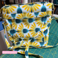 Aspen Crossbody Bag sewing project created with yellow floral fabric in white backgrpund a fashionable handmade purse.