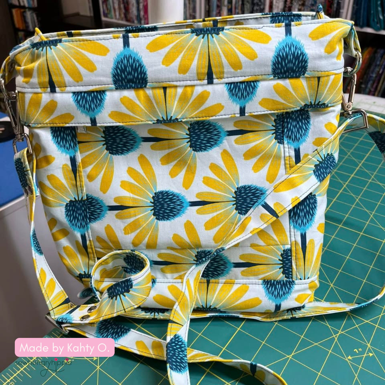 Aspen Crossbody Bag sewing project created with yellow floral fabric in white backgrpund a fashionable handmade purse.