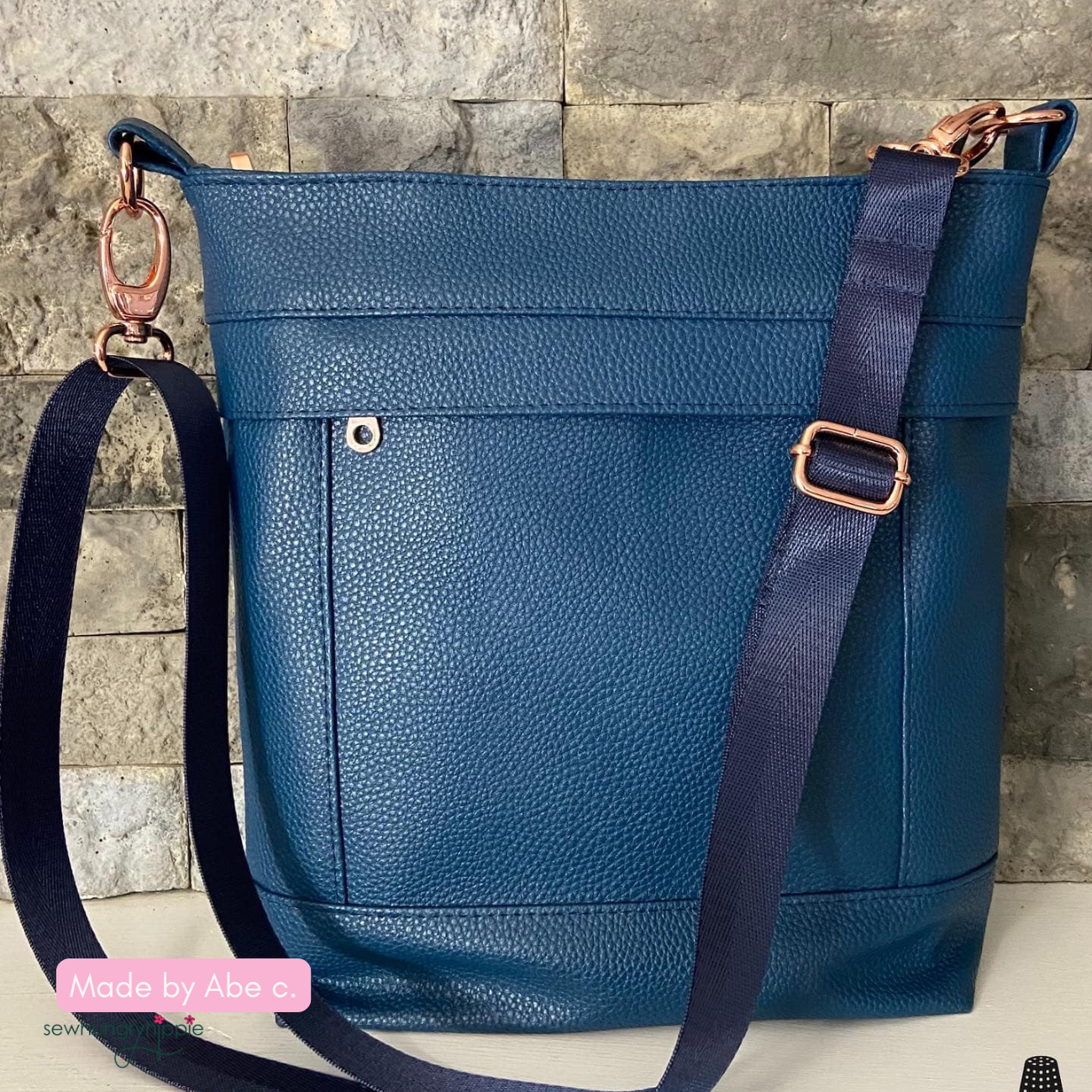 Aspen Crossbody Bag handmade with navy blue moonglow vinyl and gold hardware for webbing a unique sewing project inspiration.