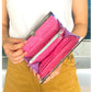 'The Wonder Wallet Clutch' pattern cover with a person holding a pink clutch with a white background