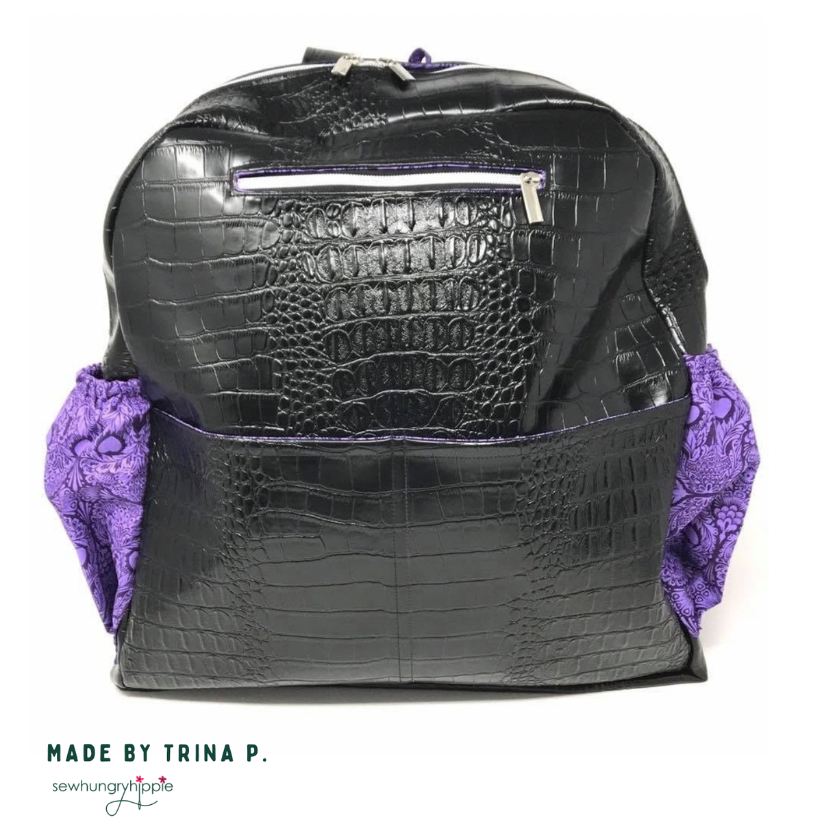 Black croc-embossed vinyl Trina Backpack with purple paisley side pockets, made by Trina P.