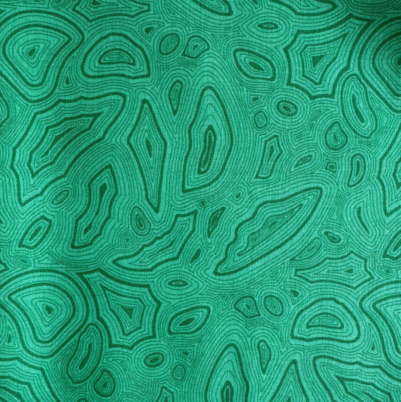 Vibrant green fabric featuring a detailed, swirling malachite gemstone pattern with dark green concentric line work.