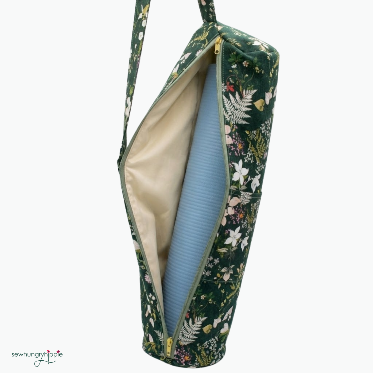 Yoga mat made in sage green zipper by the yard laid over dark green botanical floral fabric and cream canvas lining material for a sewing craft kit.