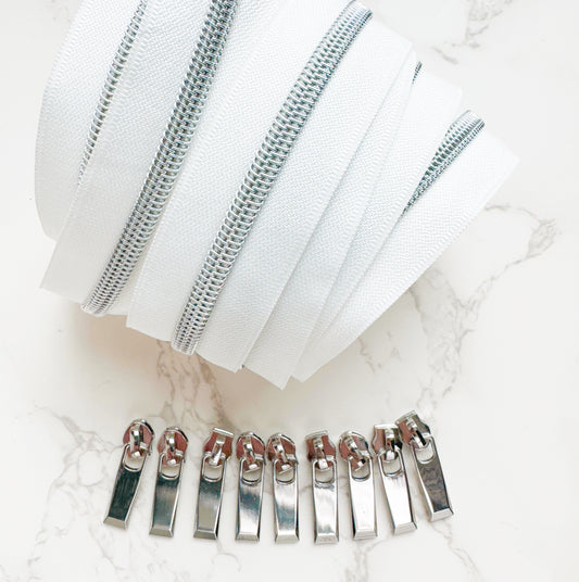 White zipper tape and silver zipper pulls.