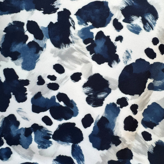 Pattern of blue and black spots on a white background