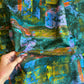 Colorful abstract painting with a hand holding a paintbrush