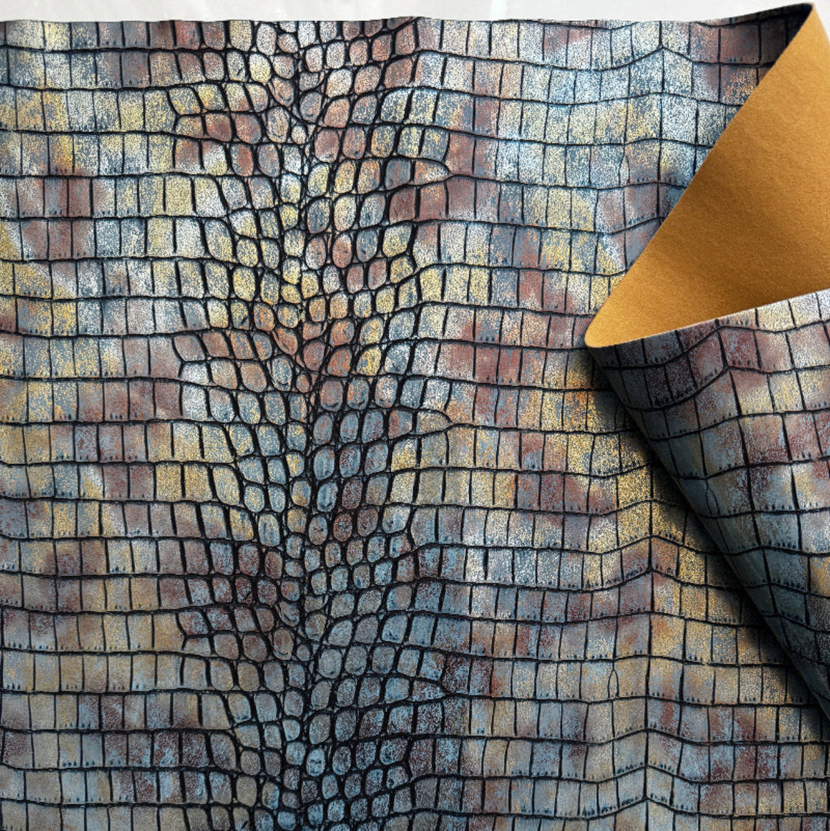 Textured fabric with a pattern resembling crocodile skin, displayed with a yellow corner.