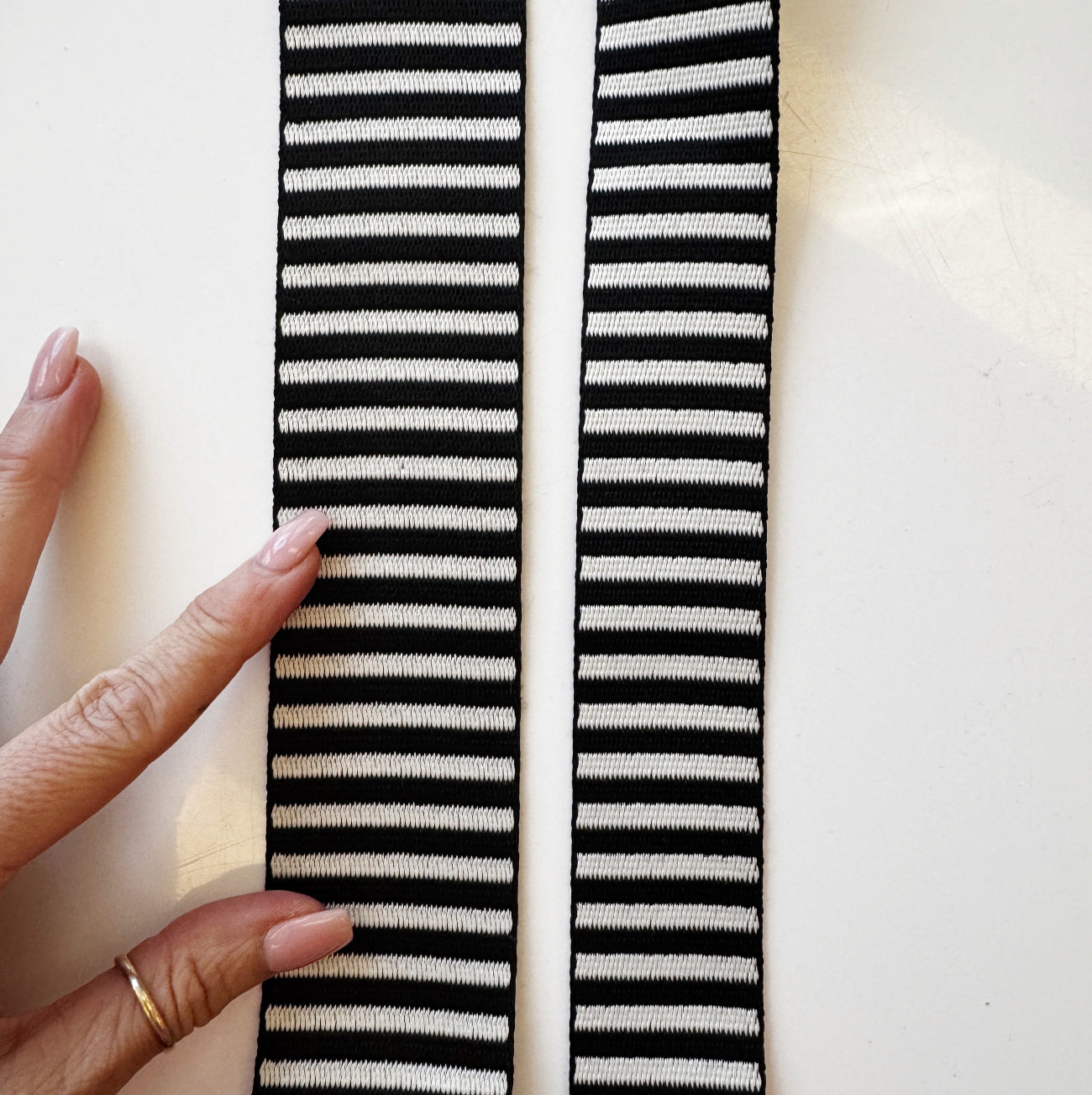 Black and white jacquard woven stripe webbing, 2-inch width, sold per yard. Strong decorative strap material for bag straps, purse handles, belts, and sewing projects.
