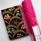 Black floral sewing fabric with gold accents and pink flowers paired with pink quilted pebbled vinyl.