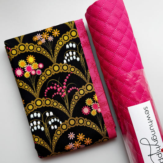 Black floral sewing fabric with gold accents and pink flowers paired with pink quilted pebbled vinyl.