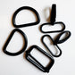 Six black metal carabiner-style hardware pieces arranged on a plain white background.