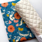 Blue floral fabric with colorful flowers and white quilted vinyl for sewing and bag making.