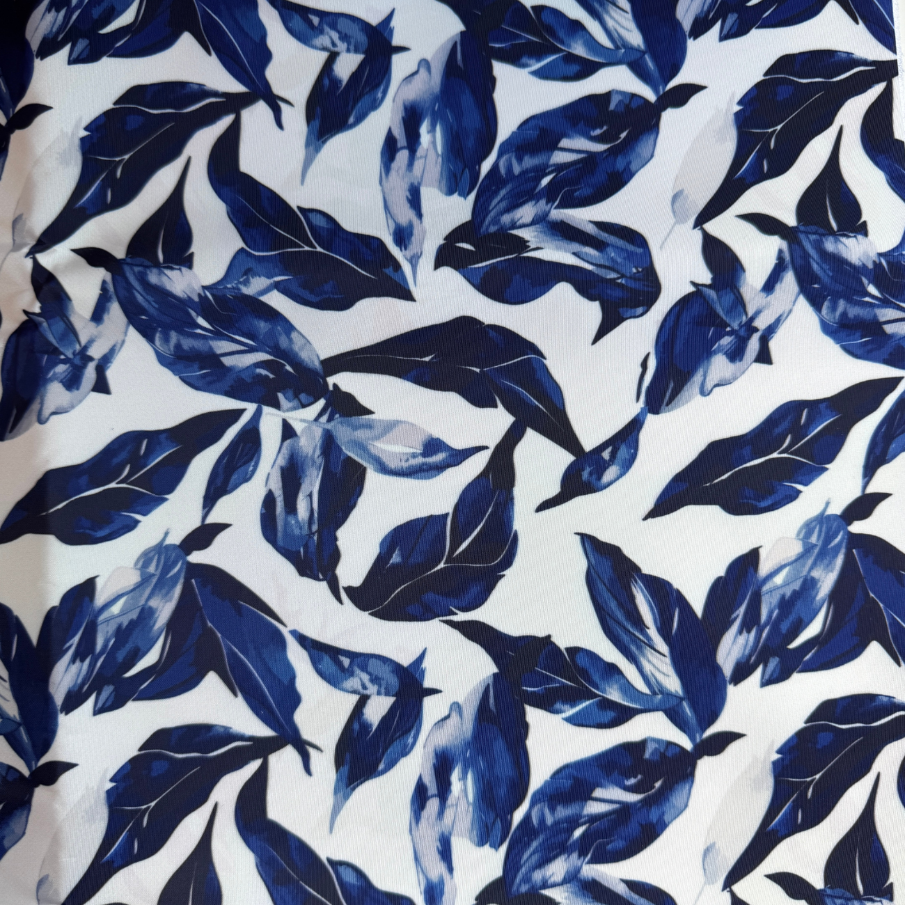 White cotton fabric featuring watercolor blue leaf print for sewing handbags, totes, wallets, and handmade accessories.